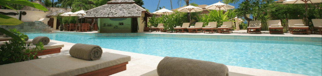 Guests practicing yoga and meditation in a tropical garden at Zuri Zanzibar