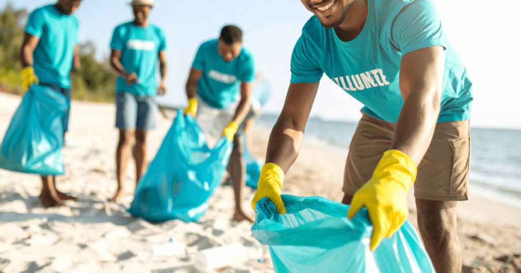 Responsible travel in action — beach cleanup and community projects for positive impact.