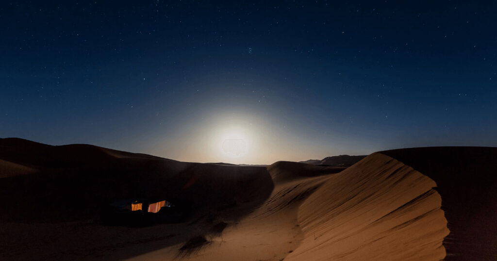 Couple enjoying Bedouin desert camp under starlit sky during romantic honeymoon Egypt