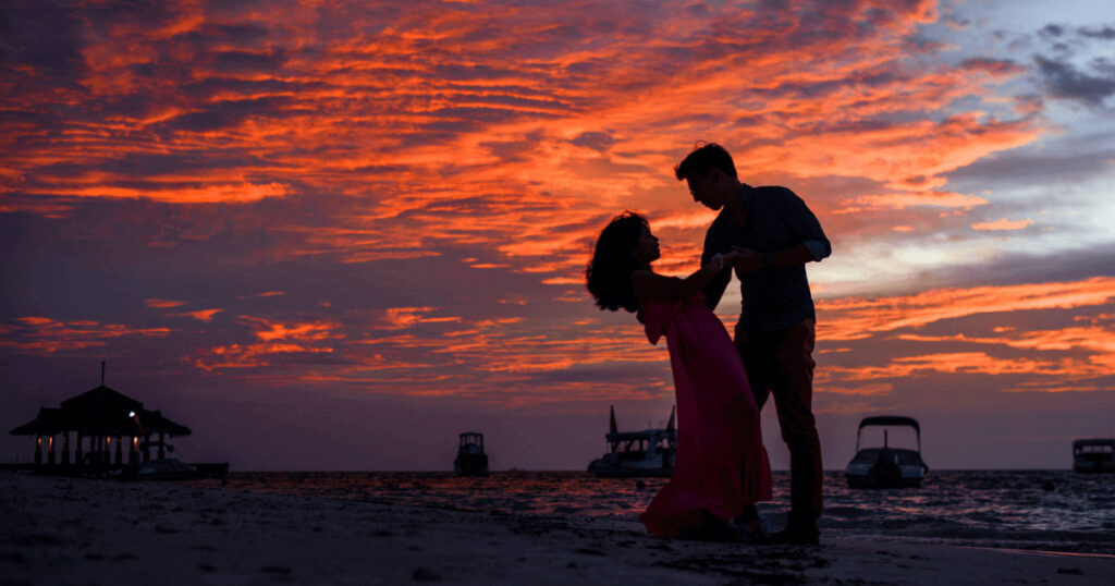 Romantic honeymoon Egypt couple walking through golden dunes at sunset